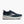 Navy running shoe with white sole on a white background