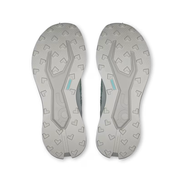 Close-up of a pair of gray athletic shoes with tread pattern on a white background