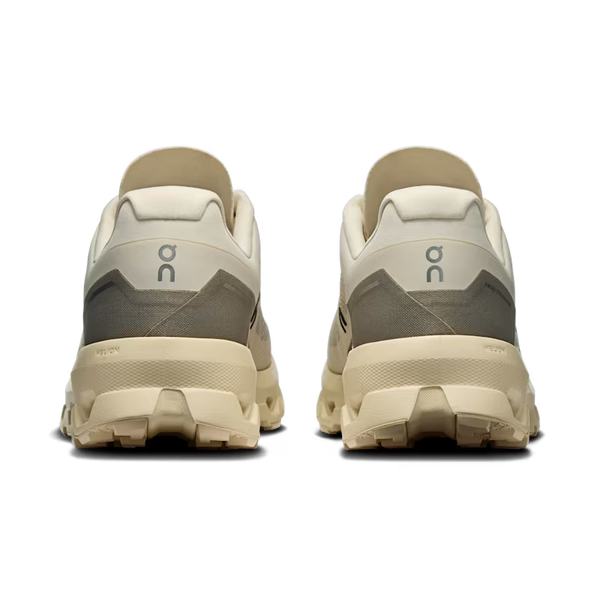 Beige and brown running shoes with visible brand logo on a white background
