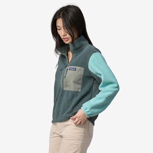 Front view of woman wearing 1/2 zip green fleece