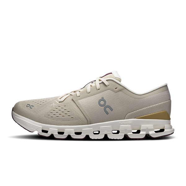Beige running shoe with a visible brand logo on a white background