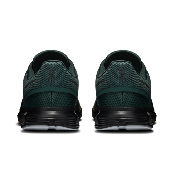 Green athletic shoes with black soles on a white background