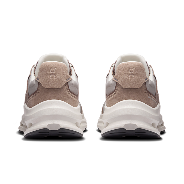 Pair of beige and white sneakers on a white background