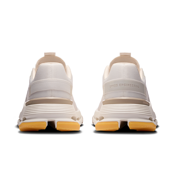 White sneakers with tan soles on a white background