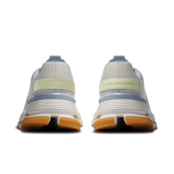 Back view of white sneakers with 'Swiss Engineering' text on a white background