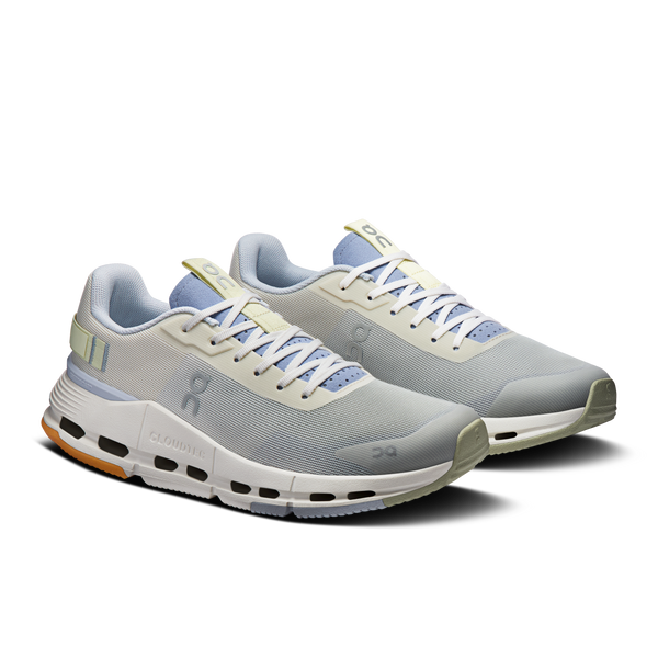 Pair of gray running shoes with white soles on a white background