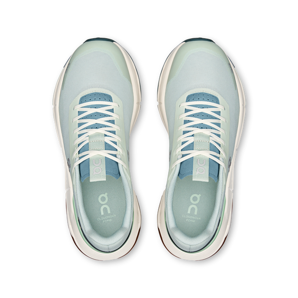 Pair of light green running shoes with white laces on a white background