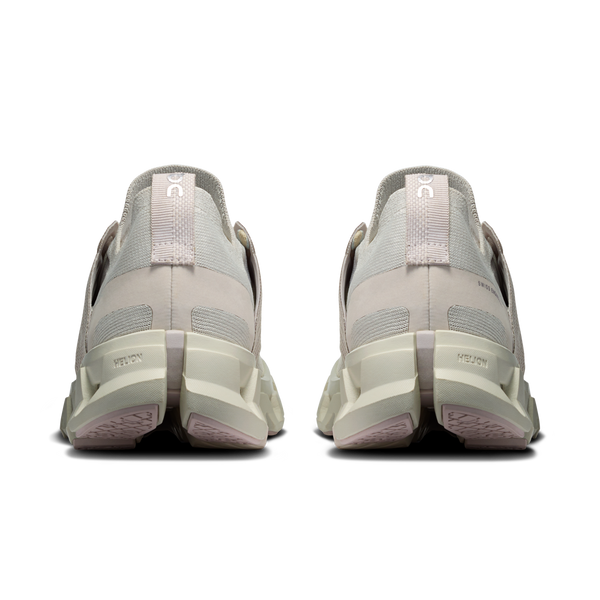 Pair of light gray sneakers shown from the back on a white background