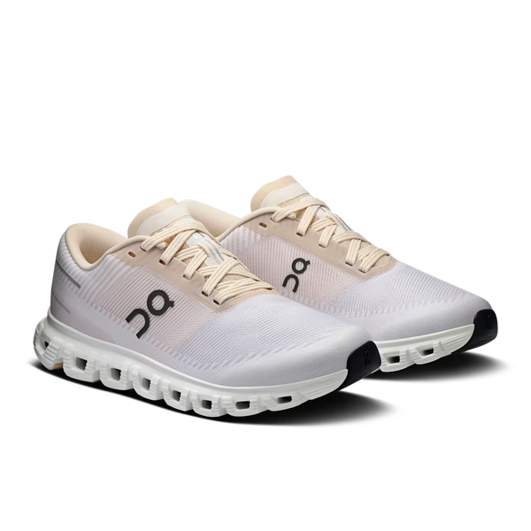 Light purple, cream and white training shoe on a white background