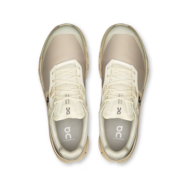 Pair of beige sneakers with white laces on a transparent background