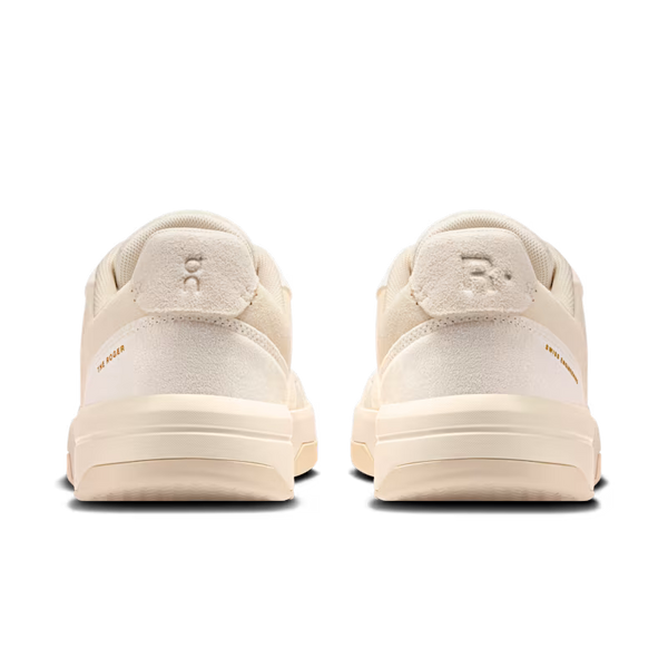 Pair of beige sneakers on a white background