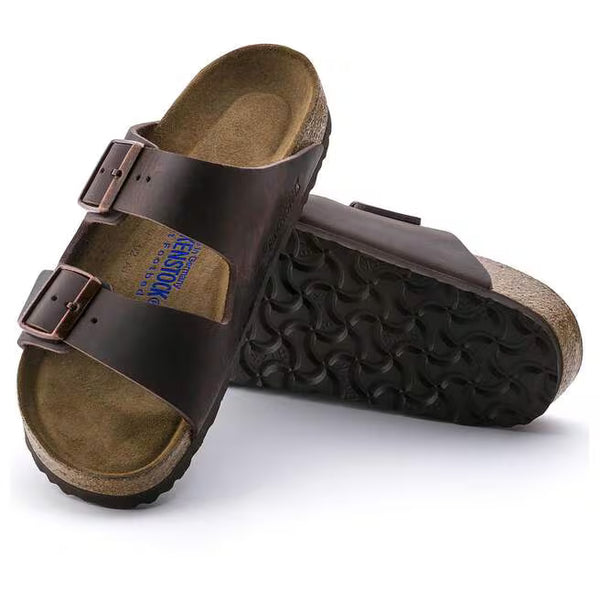 The outsole of this shoe is black and has a geometric pattern. Birkenstock is stamped into the leather upper on the medial side. 