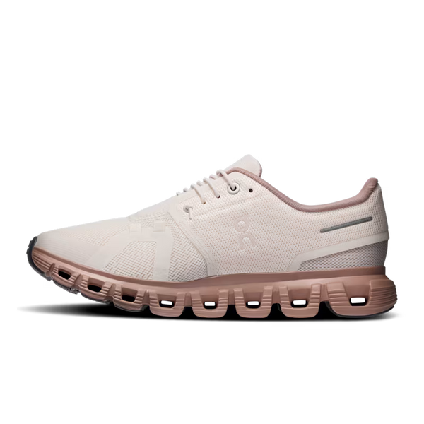 A single On running shoe in a light cream/off-white mesh upper with a dusty rose sole, shown in a side profile on a white background.