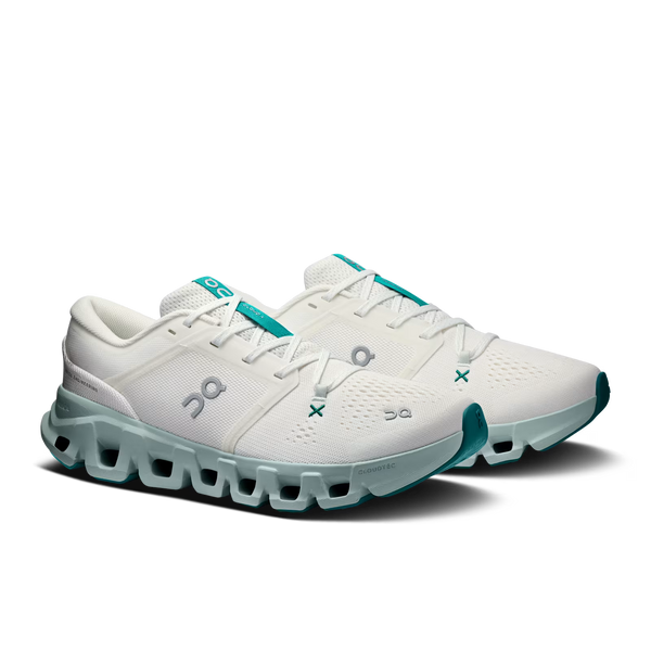 A pair of On Cloudrunning sneakers in white with teal accents on the midsole, tongue, and outsole, shown on a clean white background.