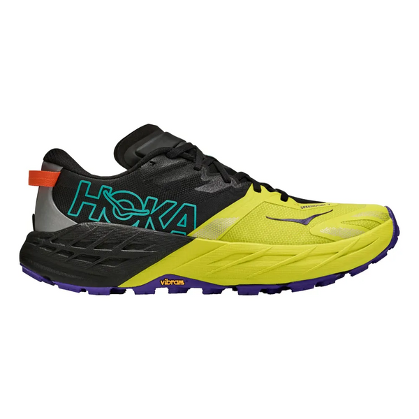 A Hoka trail running shoe in bright yellow, black, and purple, featuring a textured midsole, teal HOKA branding on the side, and a purple Vibram outsole, shown against a plain white background.