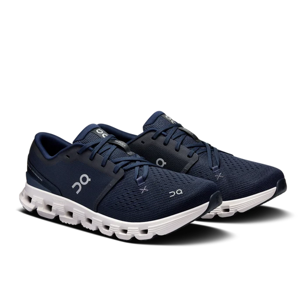 Navy and white athletic shoe on a white background