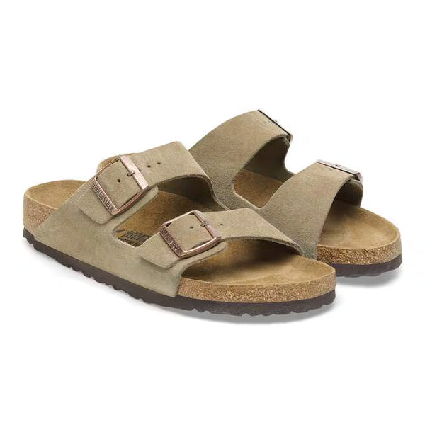 The suede upper of this Arizona is a taupe color with brass buckles. 