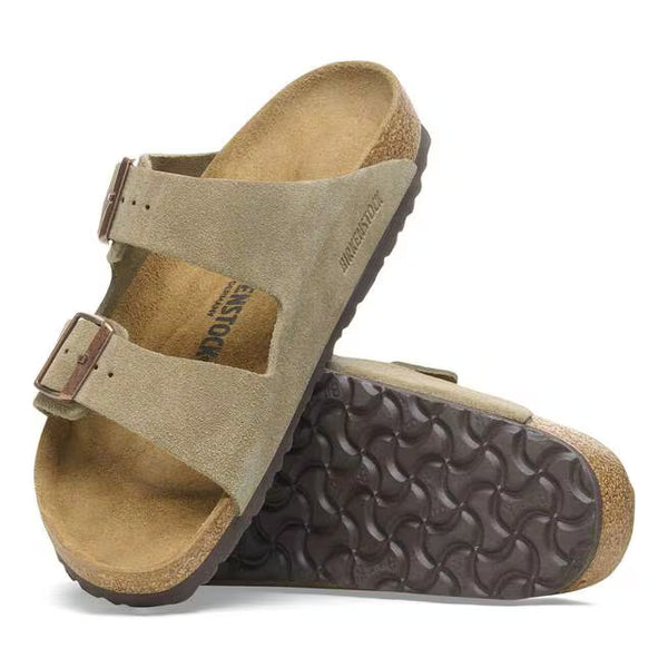 The outsole of this shoe is dark brown and has a geometric pattern. Birkenstock is stamped into the suede upper on the medial side. 