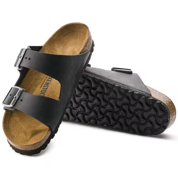The outsole of this shoe is black and has a geometric pattern. Birkenstock is stamped into the leather upper on the medial side. 