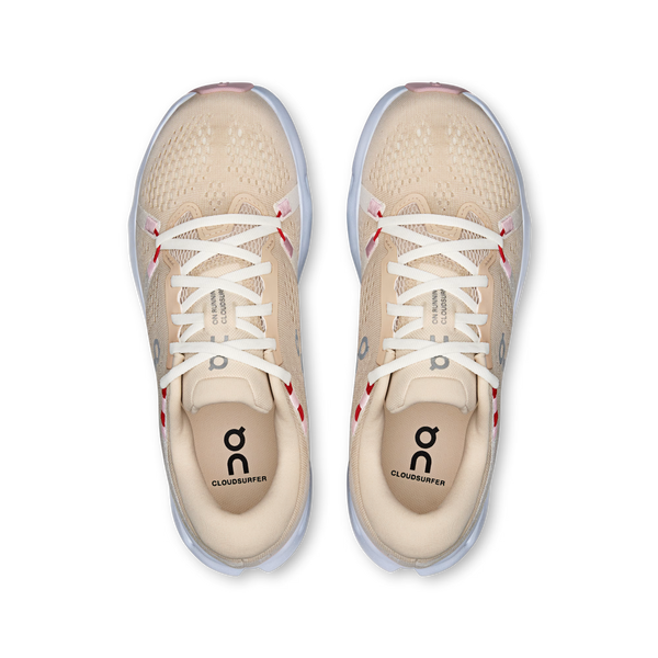 Beige running shoes with white laces on a white background