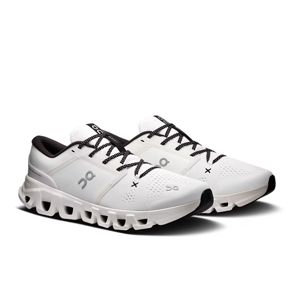 A pair of On running shoes in white with black laces, black logo details, and a black outsole, shown on a clean white background.