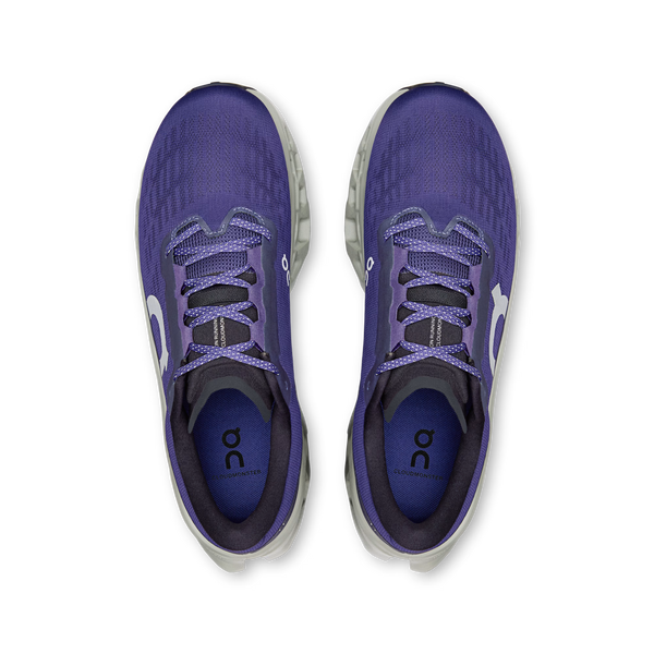 Purple running shoes with a white sole on a white background