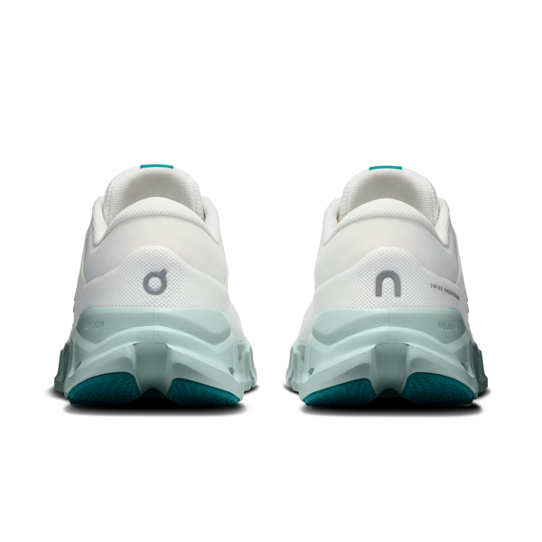 A pair of On running shoes shown from the back, featuring a white upper, a chunky translucent mint green midsole, and teal outsoles.