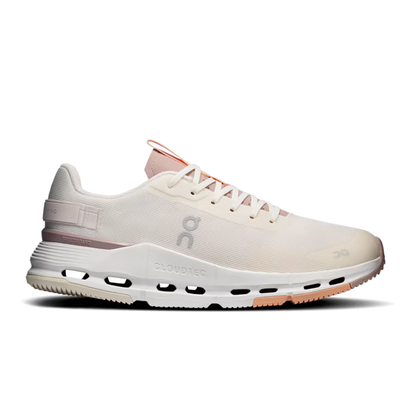A side profile view of an On Cloudtec running shoe in off-white and light pink, featuring a breathable mesh upper, cushioned CloudTec sole, and pink accents on the laces and heel.