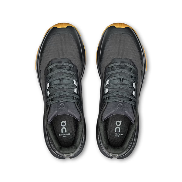 A black On running shoe with a textured mesh upper, black laces, a black midsole, and a contrasting brown outsole, on a white background.