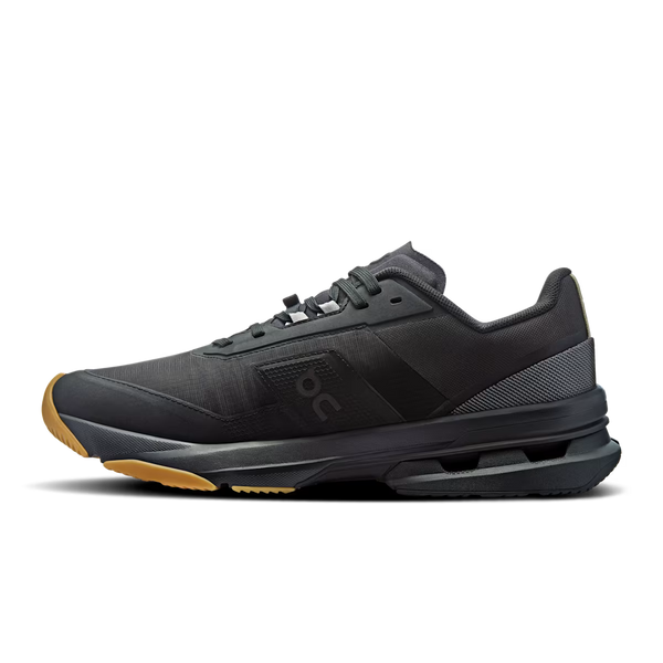 A black On running shoe with a textured mesh upper, black laces, a black midsole, and a contrasting brown outsole, on a white background.