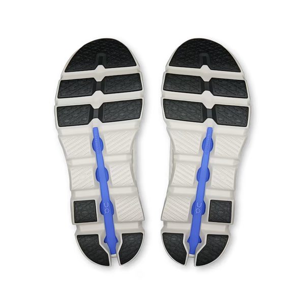 Close-up of a pair of white athletic shoes with black soles and blue arch support on a transparent background.
