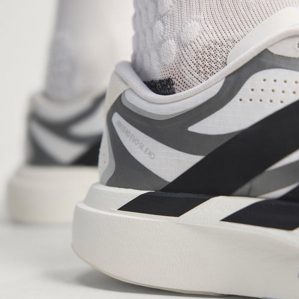 Close-up of a sneaker with black and gray design on a light background