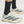 A close up of an adidas running shoe and black socks.