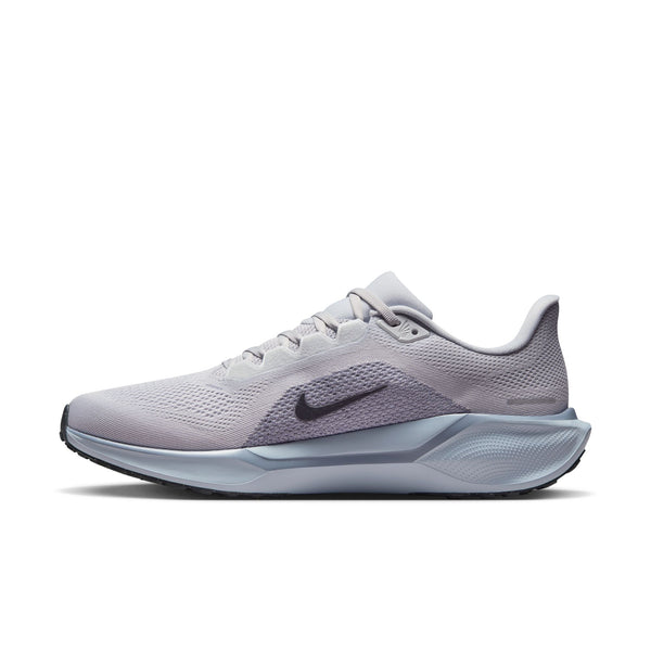 The medial side of a Nike running shoe with a black swoosh logo and a comfy looking knit on a white background.