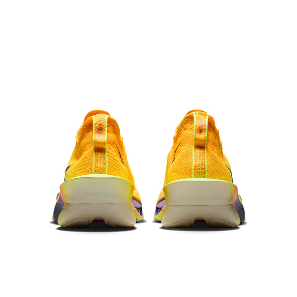 The heel of a pair of bright yellow running shoes with a white sole on a white background.