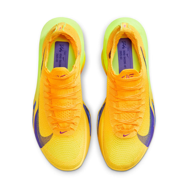 Pair of bright orange and yellow athletic shoes with purple accents on a white background.