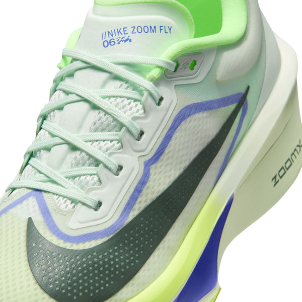 Nike Zoom Fly running shoe with green, white, and blue design on a white background