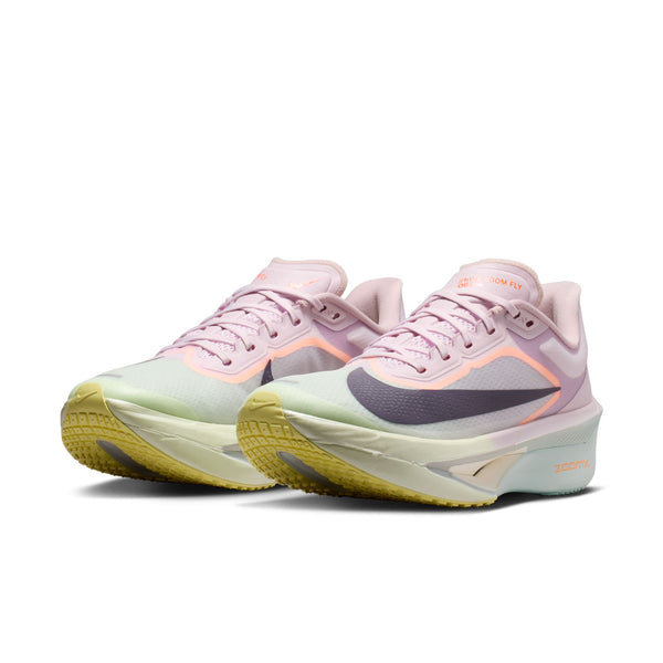 White running shoe with purple and green accents on a white background