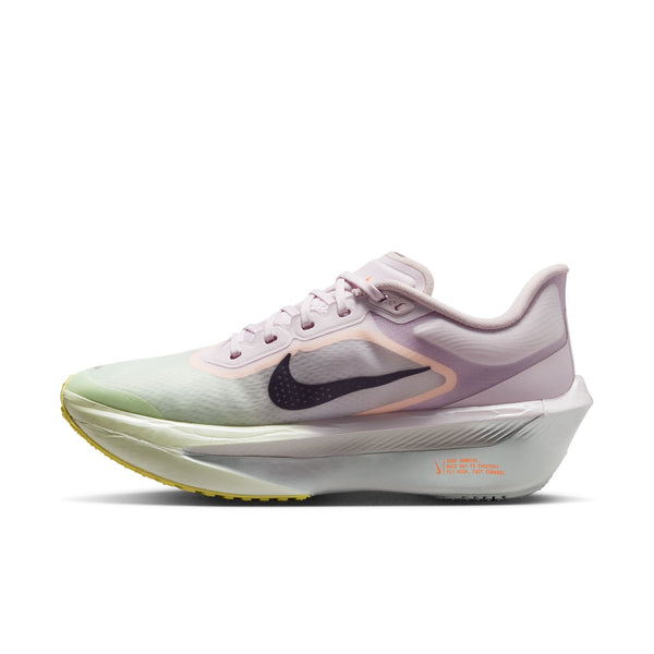 White running shoe with purple and green accents on a white background