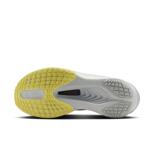 White running shoe with purple and green accents on a white background
