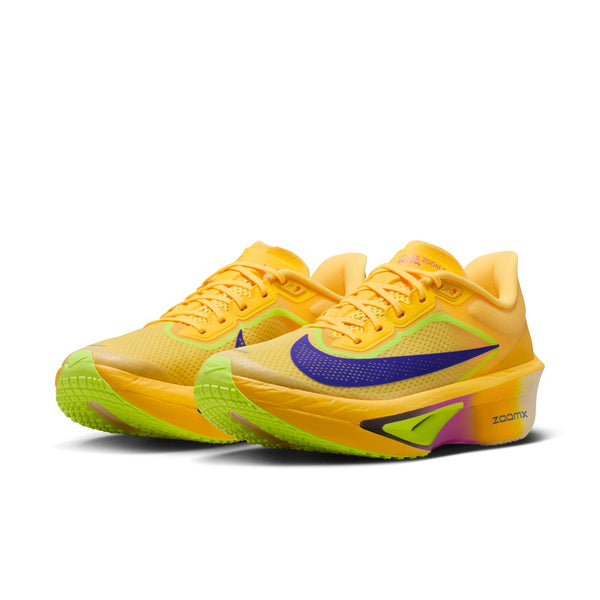 Yellow running shoes with a purple swoosh logo on a white background