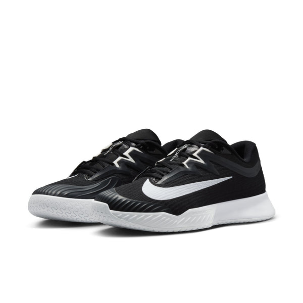A pair of Nike tennis shoes with a rubber toe bumper that helps for durability.
