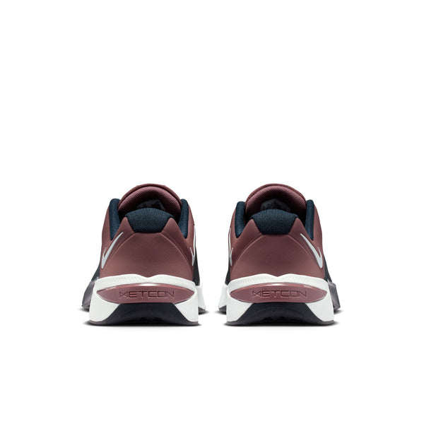 Pair of maroon and navy athletic shoes with white soles on a white background