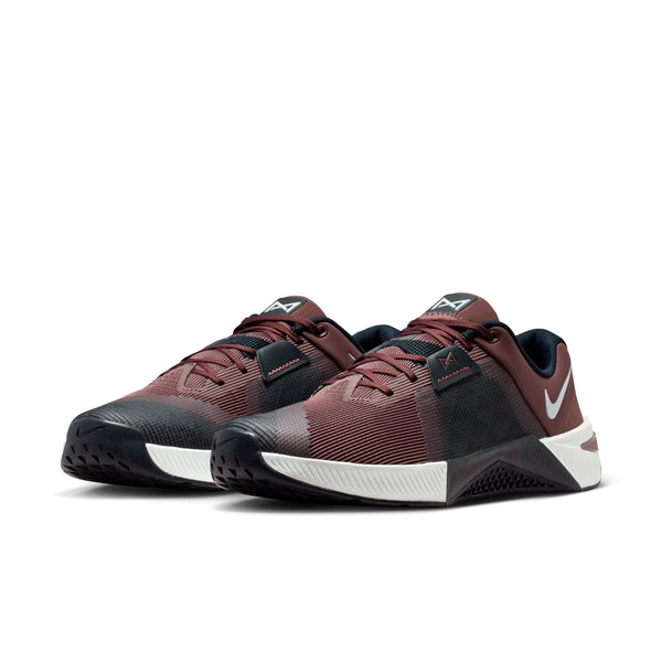 Black and red sneakers with a white sole on a white background