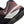 Close-up of a maroon athletic shoe with a white sole and black tread pattern.