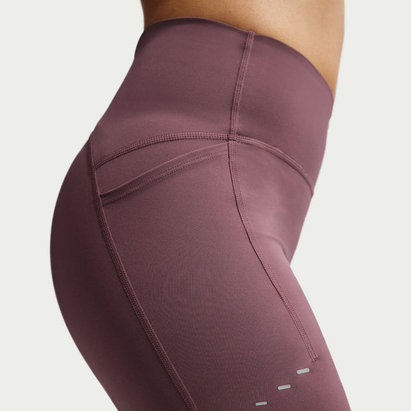 Close-up of maroon leggings with a plain background