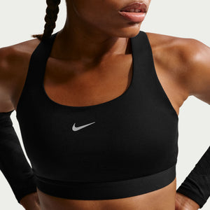 Person wearing a black Nike sports bra against a neutral background