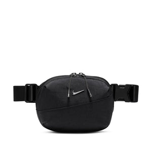 A small crossbody bag in black with a small metallic nike swoosh.