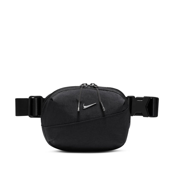 A small crossbody bag in black with a small metallic nike swoosh.