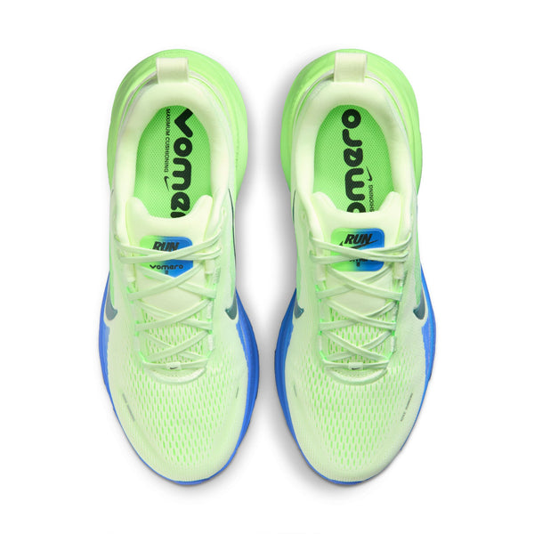 Pair of green running shoes with blue soles on a white background